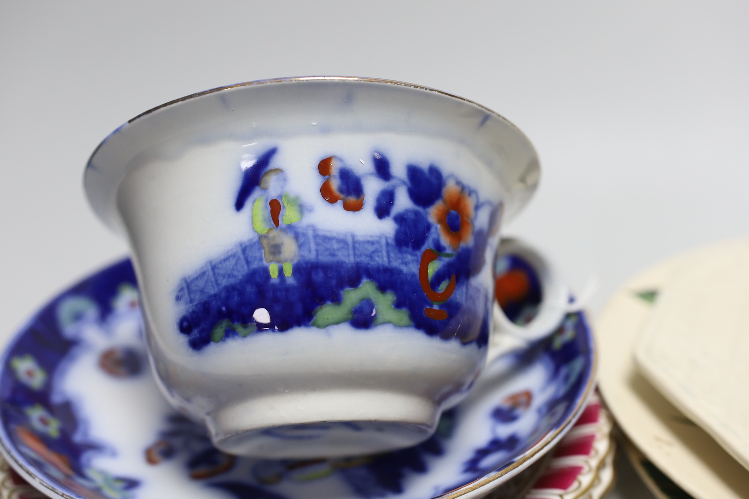 A pair of Doulton plates, a pair of floral plates, a Victorian nursery plate and a large flow blue cup and saucer